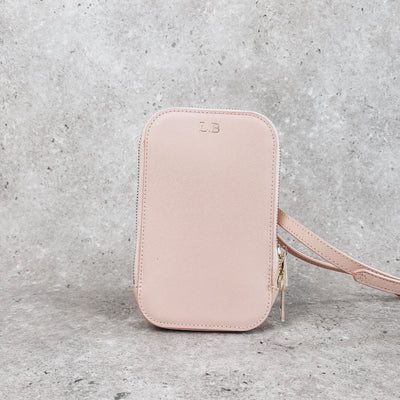 Personalised icy pink leather bag  on a grey background