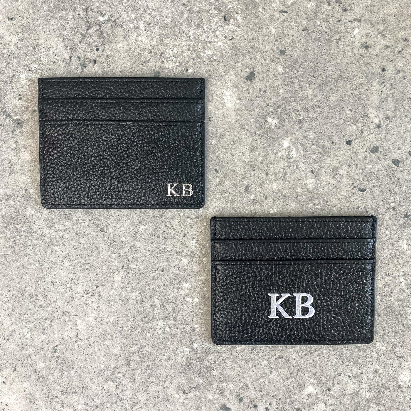 Black pebble leather card holder embossed with initials and black card holder with drop shadow