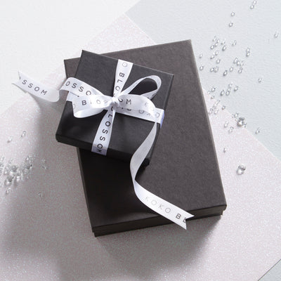 black gift box with white ribbon