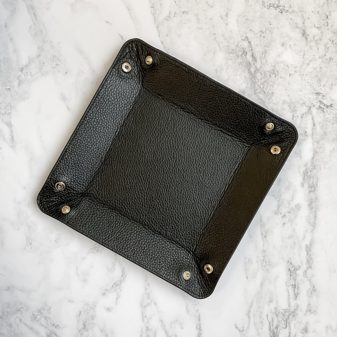 Open valet tray on a marble background