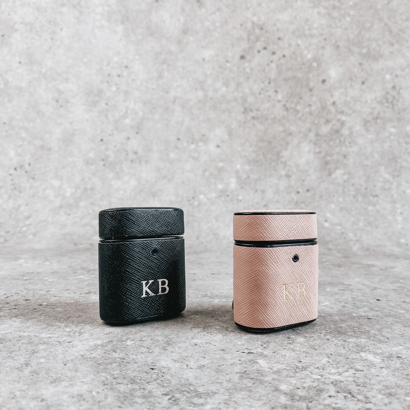 Pink AirPod holder, embossed with gold initials and Black AirPod holder, embossed with silver initials