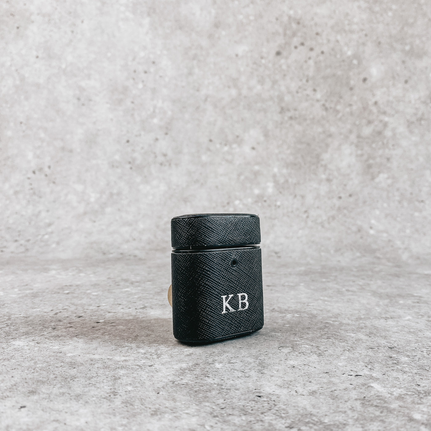 Black AirPod holder, embossed with silver initials