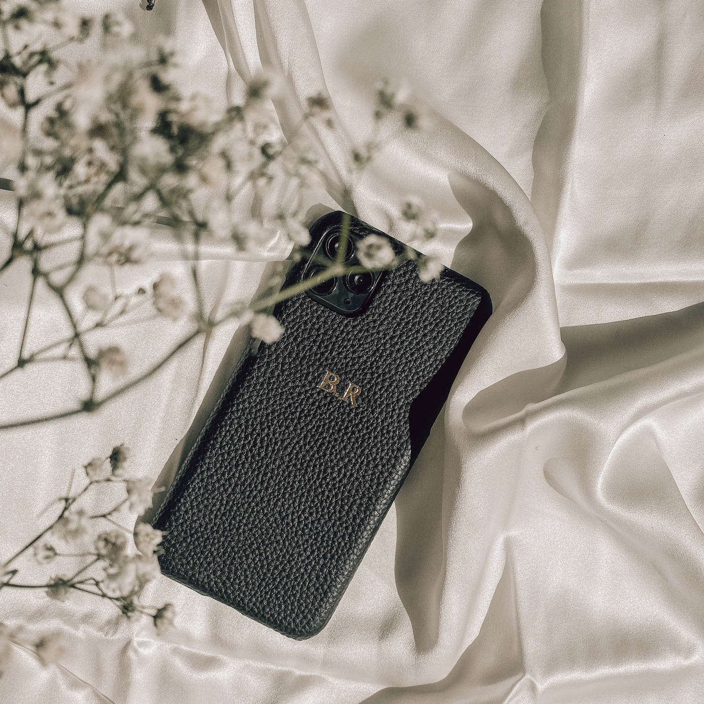 Black pebble leather phone case with embossed initials 